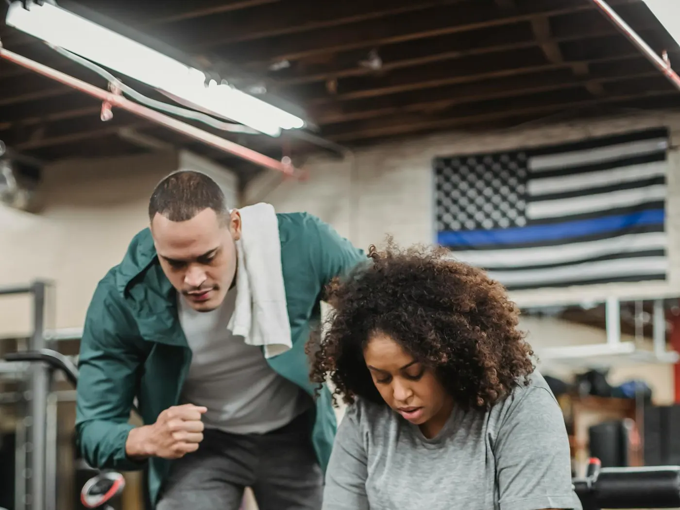 Trainer coaching a client through a strength exercise